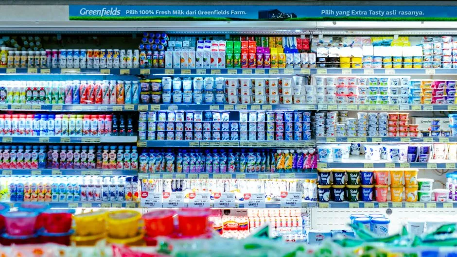 Dairy section shelves in a grocery store, illustrative stock photo